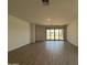 Bright living room with tile floors and sliding glass doors leading to backyard at 9544 W Parkway Dr, Tolleson, AZ 85353