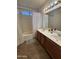 Bathroom featuring a double sink vanity, shower-tub combo, and neutral tile flooring at 970 W Leah Ln, Gilbert, AZ 85233