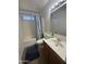 Cozy bathroom features a shower-tub combo with blue striped shower curtain and dark wood vanity at 970 W Leah Ln, Gilbert, AZ 85233