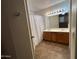 Bathroom features a double vanity, tile floors, and ample lighting at 970 W Leah Ln, Gilbert, AZ 85233