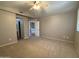 Spacious bedroom features plush carpet, a ceiling fan, and an ensuite bathroom at 970 W Leah Ln, Gilbert, AZ 85233