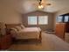 Bedroom with a ceiling fan, window, wood furnishings, and carpet at 970 W Leah Ln, Gilbert, AZ 85233