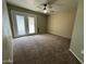 Cozy bedroom with carpet, ceiling fan, and glass doors that offer lots of natural light at 970 W Leah Ln, Gilbert, AZ 85233