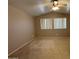 Spacious bedroom features plush carpet, a ceiling fan, and bright, natural light at 970 W Leah Ln, Gilbert, AZ 85233
