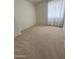 Bright, carpeted bedroom with a window, and neutral walls at 970 W Leah Ln, Gilbert, AZ 85233