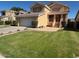 Traditional home with a well-maintained lawn, desert landscaping, and a two-car garage at 970 W Leah Ln, Gilbert, AZ 85233