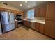Kitchen showcasing stainless steel appliances, wooden cabinets, and modern fixtures at 970 W Leah Ln, Gilbert, AZ 85233