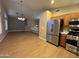 Kitchen featuring stainless steel appliances, wood cabinets, and wood floors in an open layout at 970 W Leah Ln, Gilbert, AZ 85233