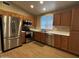 Bright kitchen featuring stainless steel appliances, wood cabinets, and modern countertops at 970 W Leah Ln, Gilbert, AZ 85233