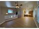 Bright living room featuring wood floors and modern lighting fixtures, seamlessly connects to the kitchen area at 970 W Leah Ln, Gilbert, AZ 85233