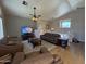 Cozy living room with hardwood flooring, a ceiling fan, leather sofas, and open living concept at 970 W Leah Ln, Gilbert, AZ 85233