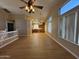 Bright living room featuring wood floors and modern lighting fixtures, seamlessly connects to the kitchen area at 970 W Leah Ln, Gilbert, AZ 85233