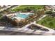 An aerial image showcases a community pool, palm trees, lounging chairs, and neighborhood amenities at 9963 W Verde Ln, Avondale, AZ 85392