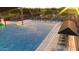 Large community pool with plenty of lounge chairs and shaded areas at 9963 W Verde Ln, Avondale, AZ 85392