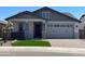 Charming single-story home featuring a two-car garage and well-manicured front yard with synthetic grass at 9963 W Verde Ln, Avondale, AZ 85392