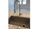 Close-up of kitchen sink with a modern, stainless steel faucet and beautiful granite countertop detail at 9963 W Verde Ln, Avondale, AZ 85392