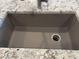 Close-up of the gray kitchen sink, highlighting its modern design and granite countertop at 9963 W Verde Ln, Avondale, AZ 85392