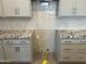 Kitchen area with granite countertops, gray cabinets, and a designated spot for a gas oven or range at 9963 W Verde Ln, Avondale, AZ 85392