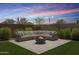 Inviting backyard seating area with a cozy fire pit and lush artificial grass at 10221 E Wavelength Ave, Mesa, AZ 85212