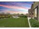 Beautiful backyard with artificial turf, outdoor seating, and view of the neighborhood at 10221 E Wavelength Ave, Mesa, AZ 85212