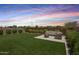 Spacious backyard featuring an outdoor seating area, firepit and artificial turf at 10221 E Wavelength Ave, Mesa, AZ 85212