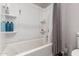 Bright bathroom featuring a tub with shower and ample shelving for storage at 10221 E Wavelength Ave, Mesa, AZ 85212
