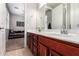 Bathroom featuring double sinks, granite countertop and access to bedroom at 10221 E Wavelength Ave, Mesa, AZ 85212