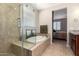 Bathroom featuring tub, glass-enclosed shower, and vanity with granite counters at 10221 E Wavelength Ave, Mesa, AZ 85212