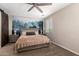 Bedroom featuring a king bed, ceiling fan, and decorative forest tapestry at 10221 E Wavelength Ave, Mesa, AZ 85212