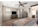 Bedroom featuring dresser, TV, fan and ensuite bathroom access at 10221 E Wavelength Ave, Mesa, AZ 85212