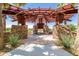 Stone gazebo offering shaded seating and a charming gathering spot with landscaping and open space views at 10221 E Wavelength Ave, Mesa, AZ 85212