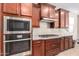 Close-up of modern kitchen appliances and granite countertops, complemented by dark wood cabinetry at 10221 E Wavelength Ave, Mesa, AZ 85212