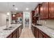Modern kitchen with stainless steel appliances, granite counters, and a convenient pantry at 10221 E Wavelength Ave, Mesa, AZ 85212