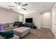 Upstairs loft area featuring a large sectional sofa and a large tv at 10221 E Wavelength Ave, Mesa, AZ 85212