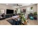 Cozy living room with a large sectional sofa, a modern entertainment center, and ample natural light at 10221 E Wavelength Ave, Mesa, AZ 85212