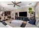 Open-concept living space with comfortable seating, a large television, and seamless flow to the dining area at 10221 E Wavelength Ave, Mesa, AZ 85212