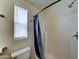 Bright bathroom featuring a shower, toilet, and window that provides natural light at 111 S Greenfield Rd # 244, Mesa, AZ 85206