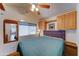 Cozy bedroom with ceiling fan, warm lighting, and built-in storage for convenience at 111 S Greenfield Rd # 244, Mesa, AZ 85206