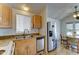 Open-concept kitchen with stainless steel appliances and view into dining area at 111 S Greenfield Rd # 244, Mesa, AZ 85206