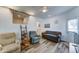 Cozy living room with innovative loft storage, comfortable seating, and stylish vinyl flooring at 111 S Greenfield Rd # 244, Mesa, AZ 85206