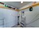 Organized utility room with storage shelves, vacuum, and ladder for household needs at 111 S Greenfield Rd # 244, Mesa, AZ 85206