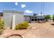 Backyard area with a shed, small garden with flowers, a sunroom, and brick features at 126 N 58Th St, Mesa, AZ 85205