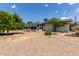 Backyard featuring a sun room, decorative brick features, and a tree in gravel at 126 N 58Th St, Mesa, AZ 85205