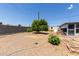 Backyard with gravel and trees and a sunroom with brick details on house at 126 N 58Th St, Mesa, AZ 85205