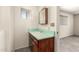 Bathroom with mint-colored vanity, a sink, and access to the bedroom at 126 N 58Th St, Mesa, AZ 85205