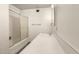 Bathroom featuring a shower and tub combo, white sink, and all-white walls at 126 N 58Th St, Mesa, AZ 85205