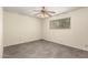 Light and airy bedroom features a ceiling fan, gray tile flooring, and a window with natural light at 126 N 58Th St, Mesa, AZ 85205