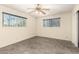 Bright bedroom filled with natural light, gray tile flooring, and neutral-colored walls at 126 N 58Th St, Mesa, AZ 85205