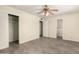 This bedroom features neutral walls and floors, a ceiling fan, and easy access to the bathroom at 126 N 58Th St, Mesa, AZ 85205