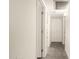 Hallway with white walls, recessed lighting, multiple closets, and gray tile flooring at 126 N 58Th St, Mesa, AZ 85205